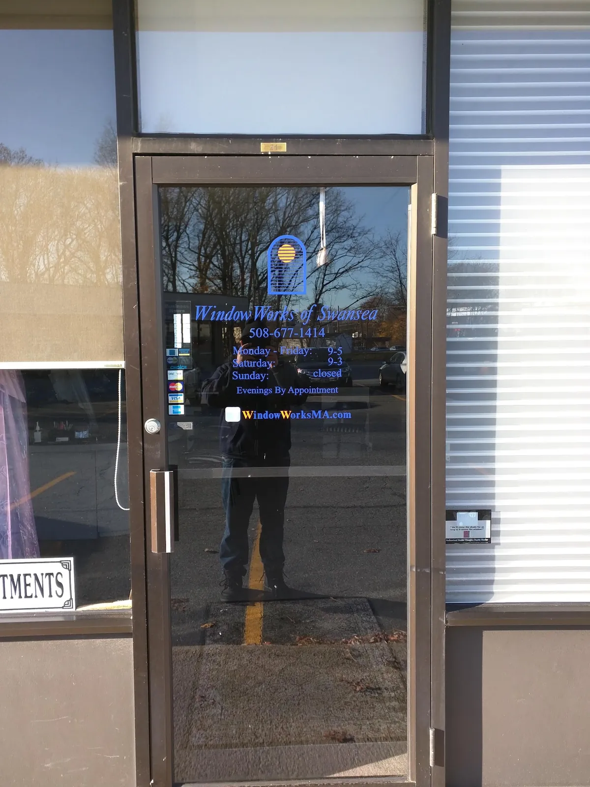 The Window Works showroom entrance on Milford Road, a glass door with the store name on it