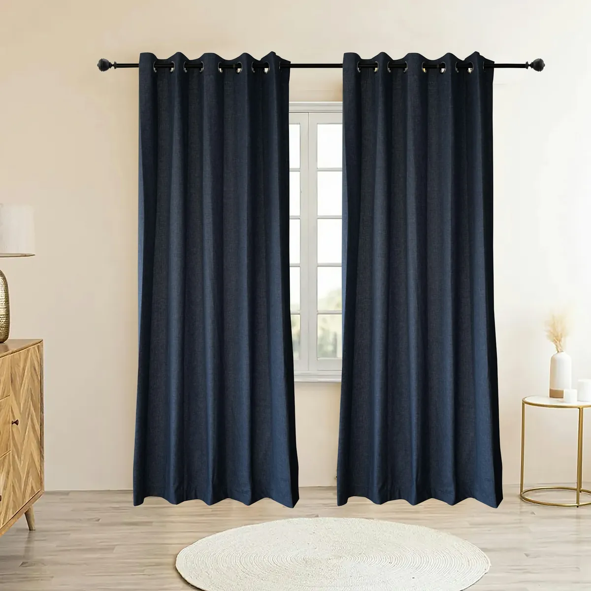 Navy grommet curtains on a black rod at a window
