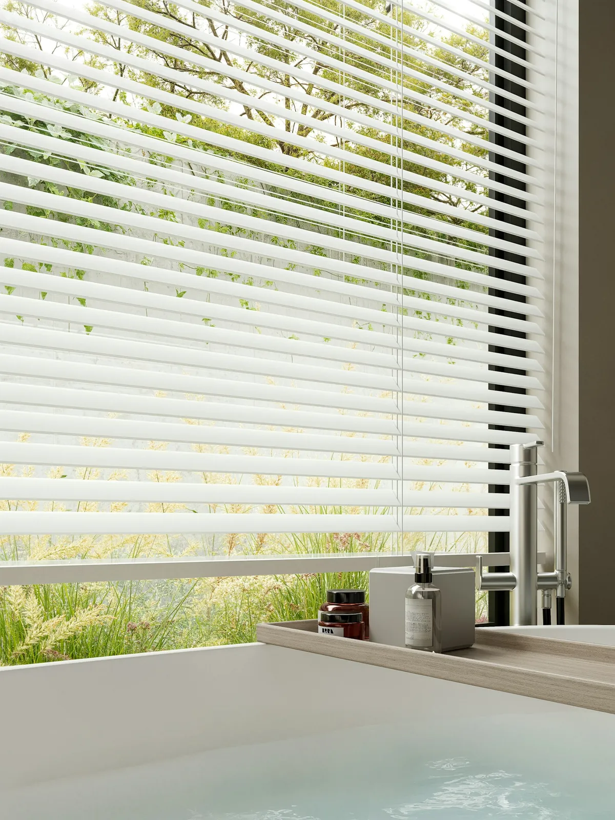 White blinds over a large bathroom window beside a bathtub