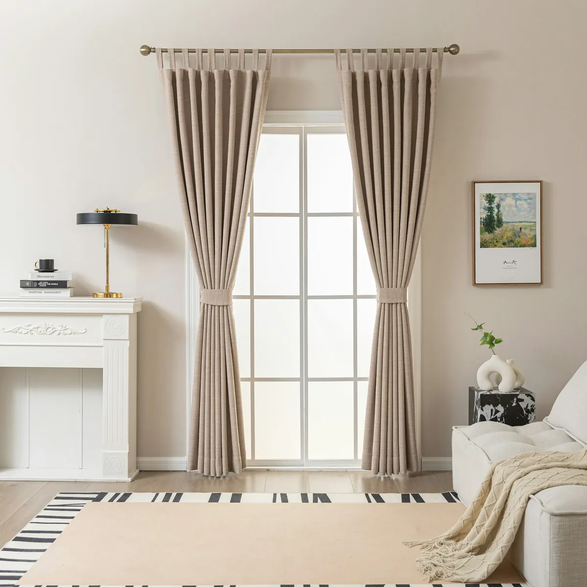 Lined beige pinch-pleat curtains on a rod at glass doors in a light living room