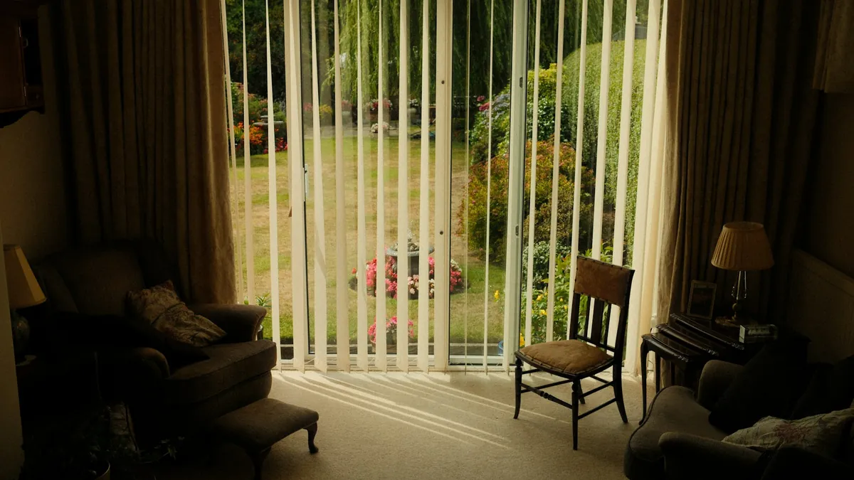 Vertical blinds drawn back from a garden door in a living room