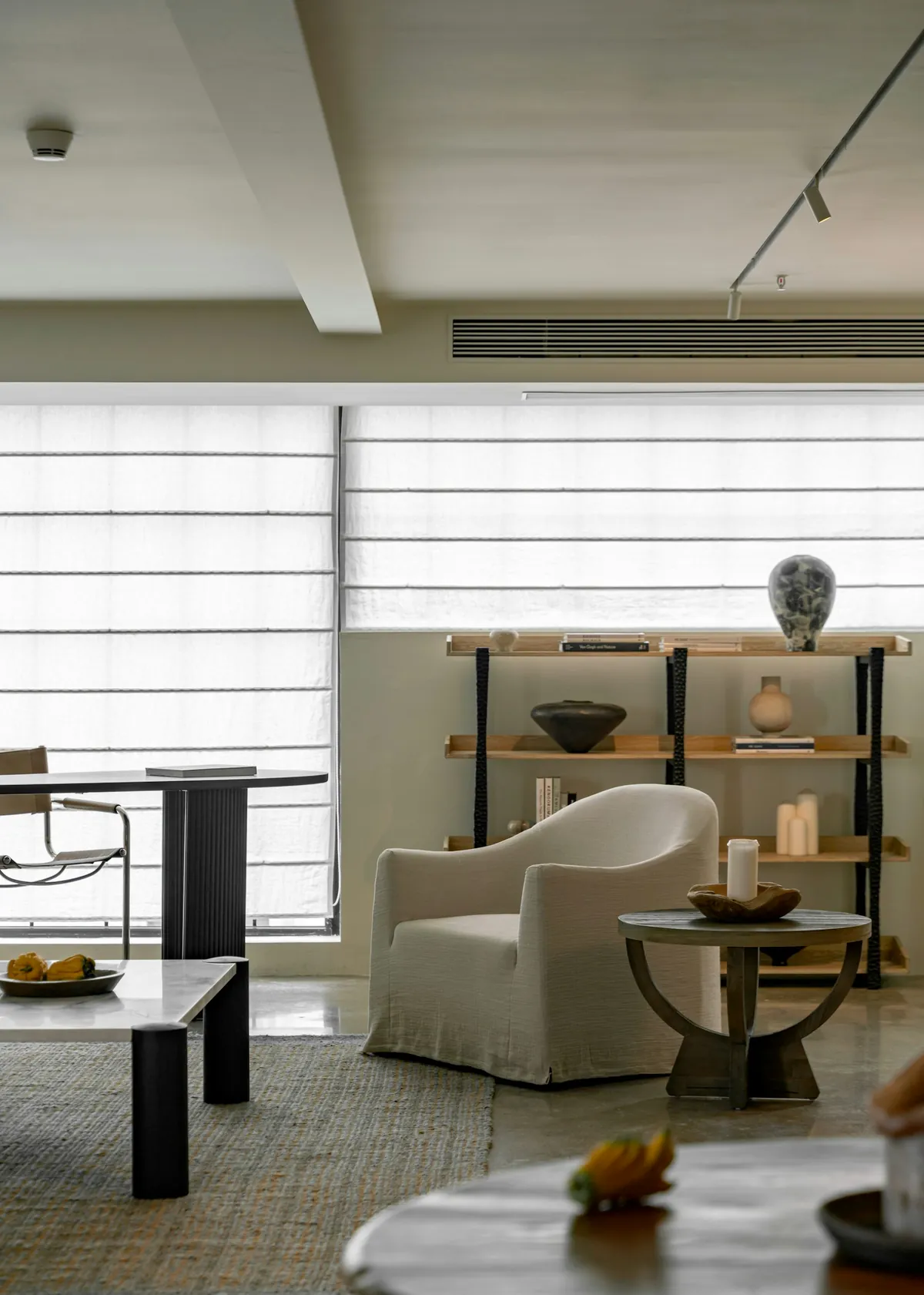 Banded shades across a wall of windows in an open living room